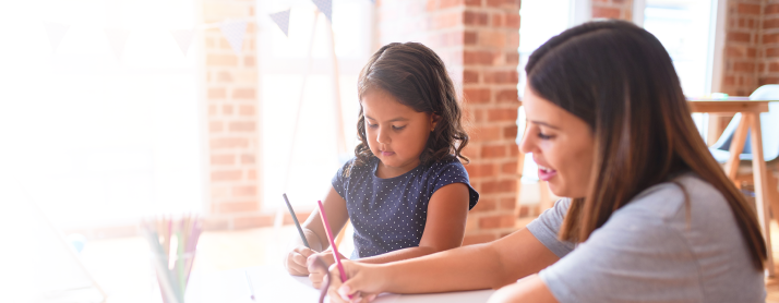 A parent and their child coloring together